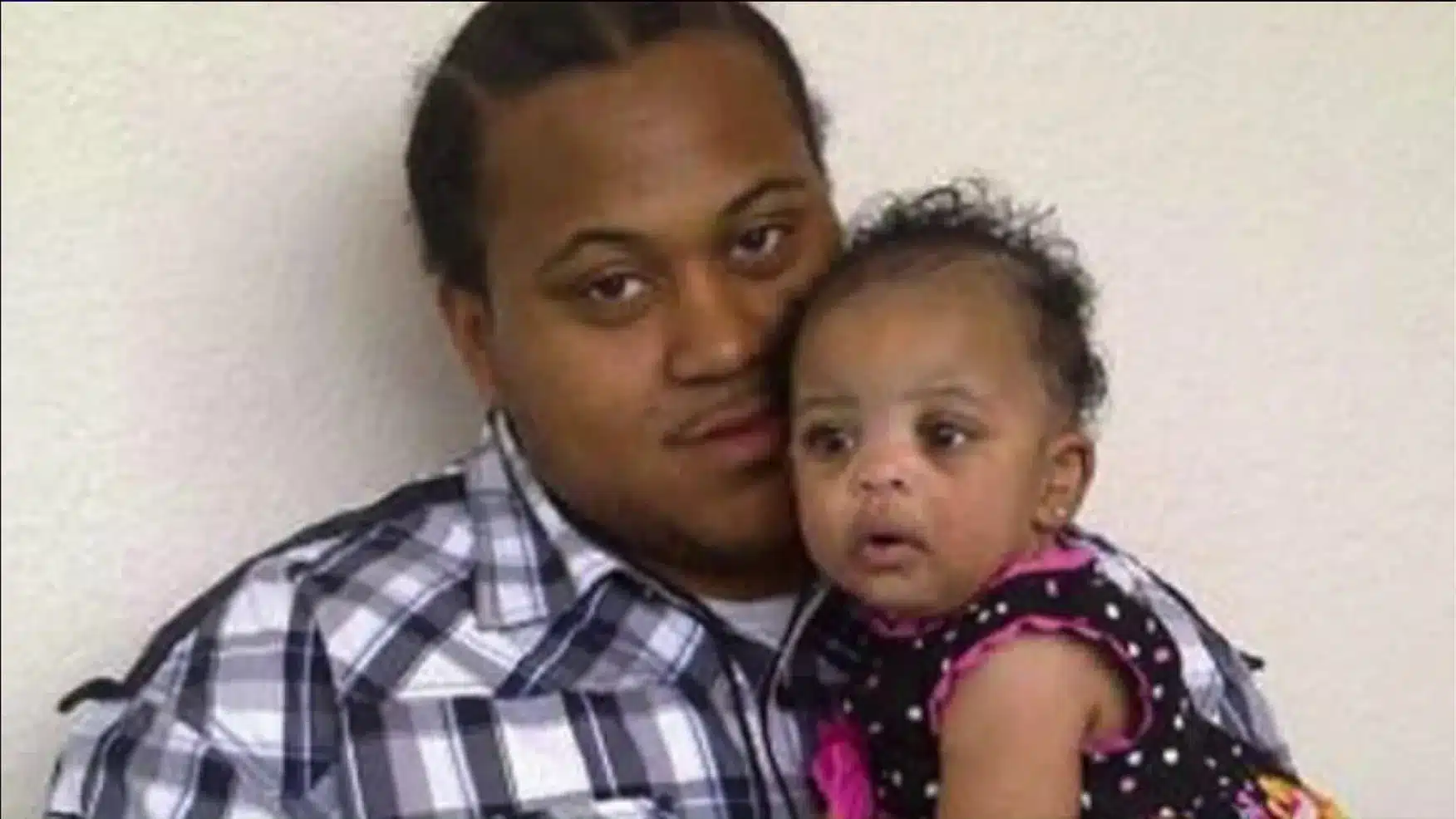 Ryan Stokes holding his one-year-old daughter.