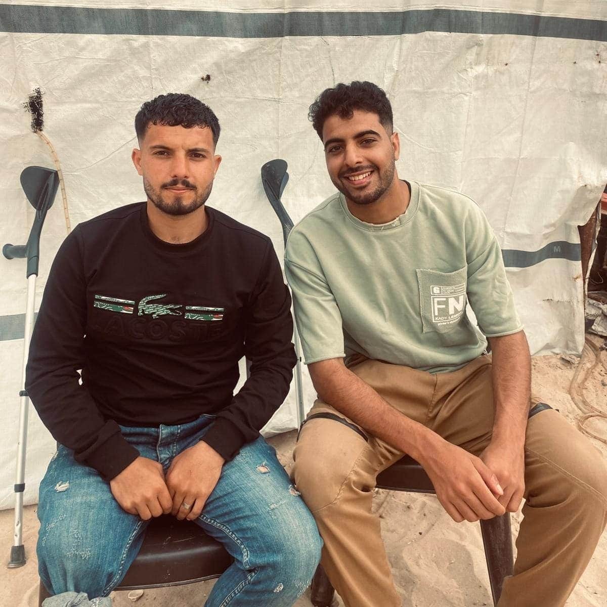 Hassan (left) and his friend Al-Asmar sit together in an Al-Mawasi encampment