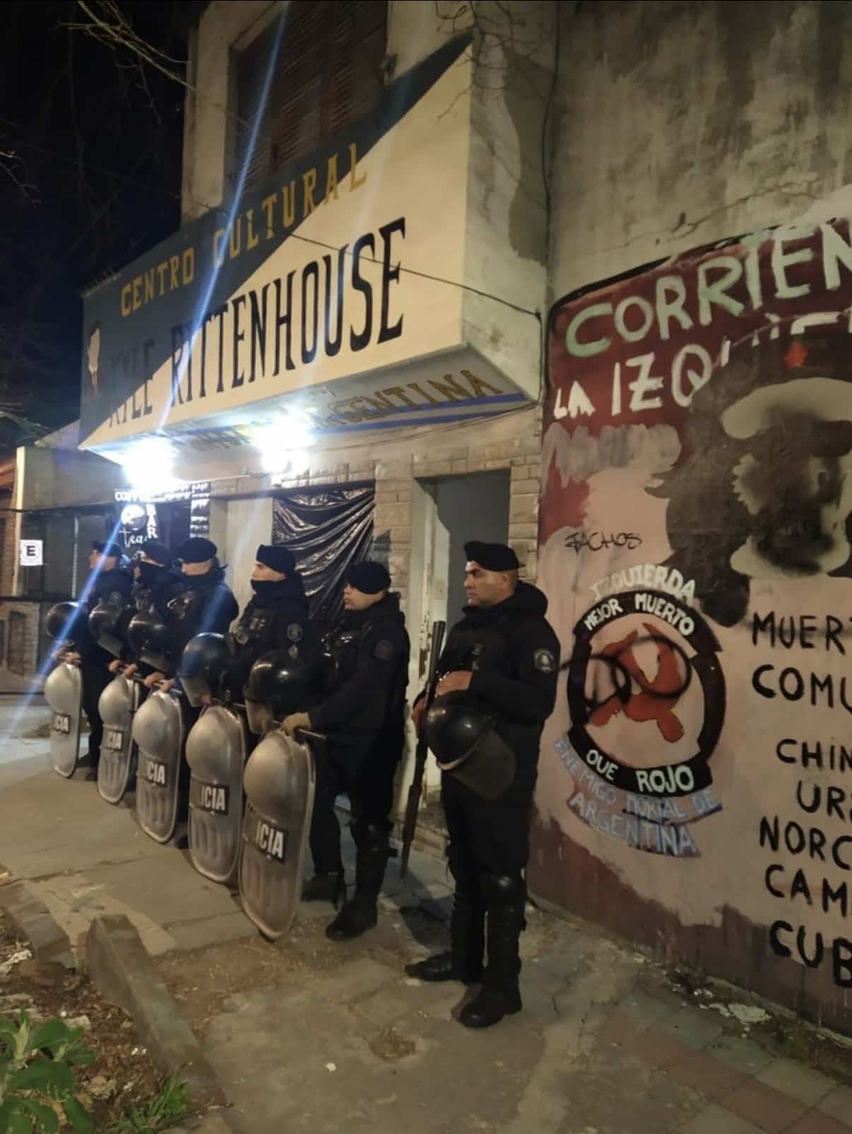 Riot police standing outside the Centro Cultural Kyle Rittenhouse in La Plata