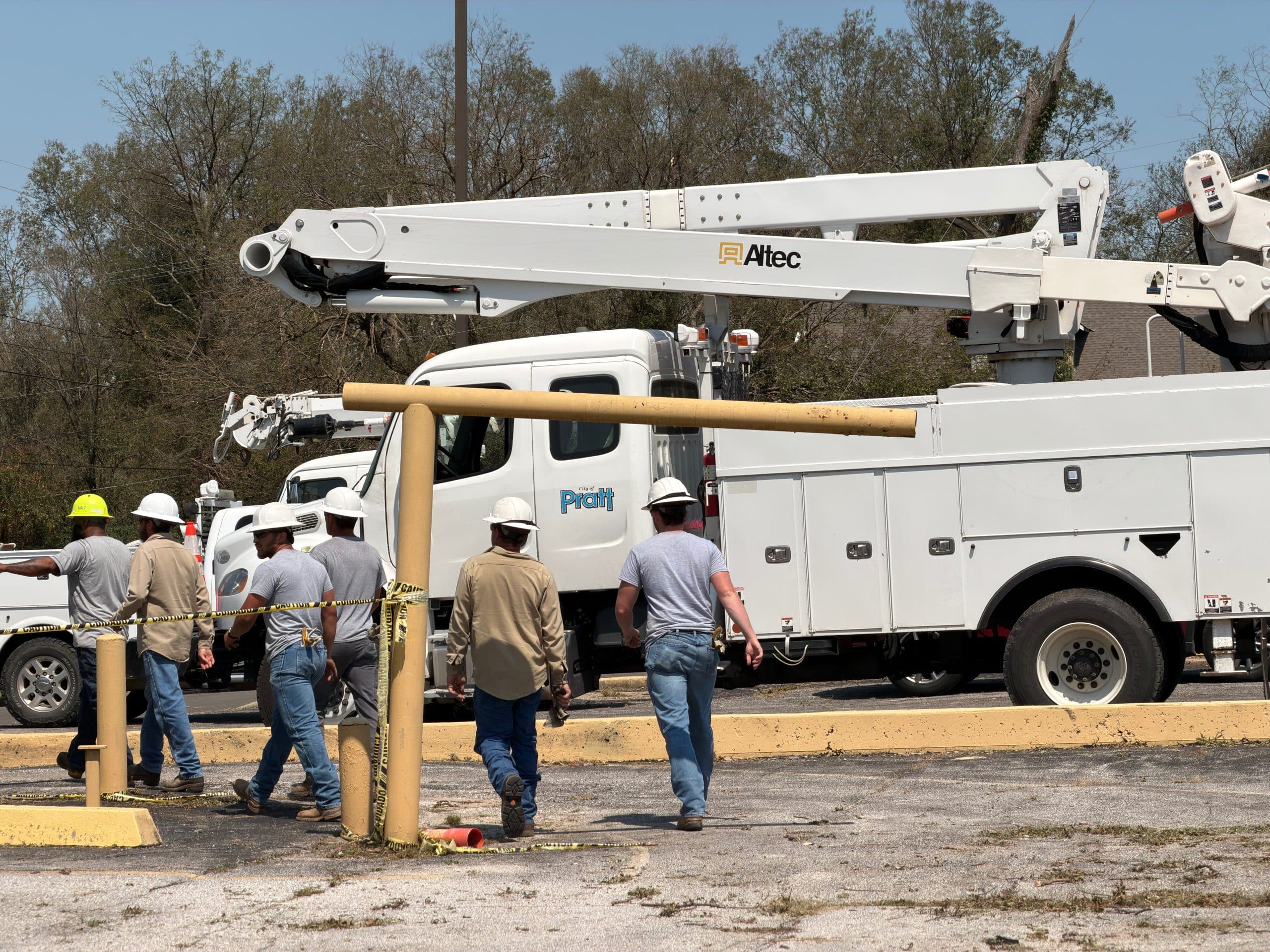 Utility crews walking toward a repair site