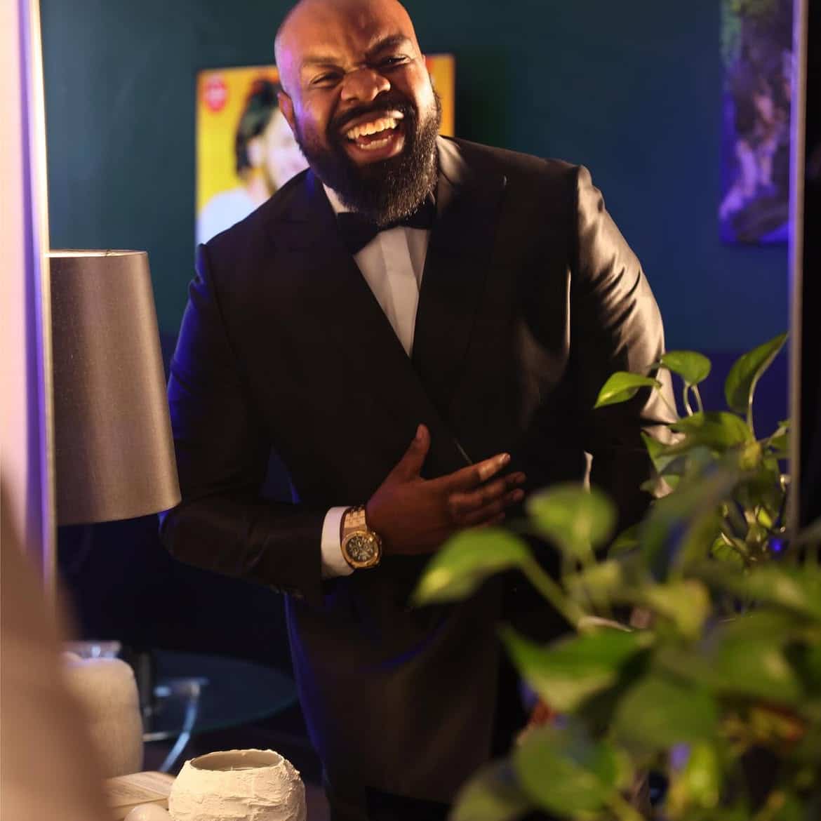Brandon Calloway laughs in a black tuxedo and bow tie.