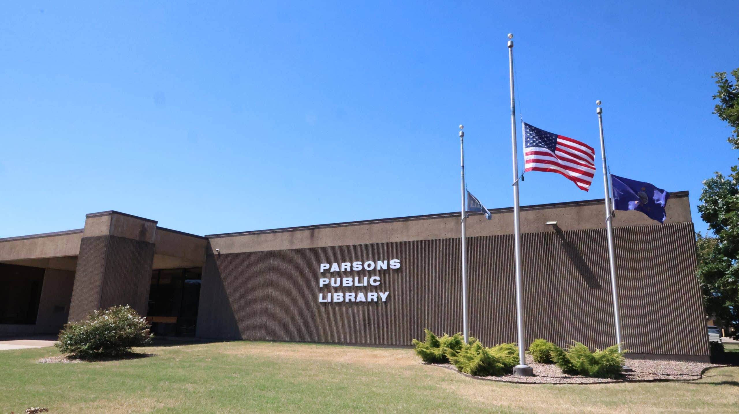 The Parsons Public Library, flags out front.