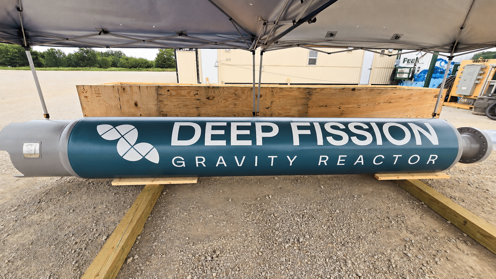 A Deep Fission Gravity Reactor canister displayed under a canopy.
