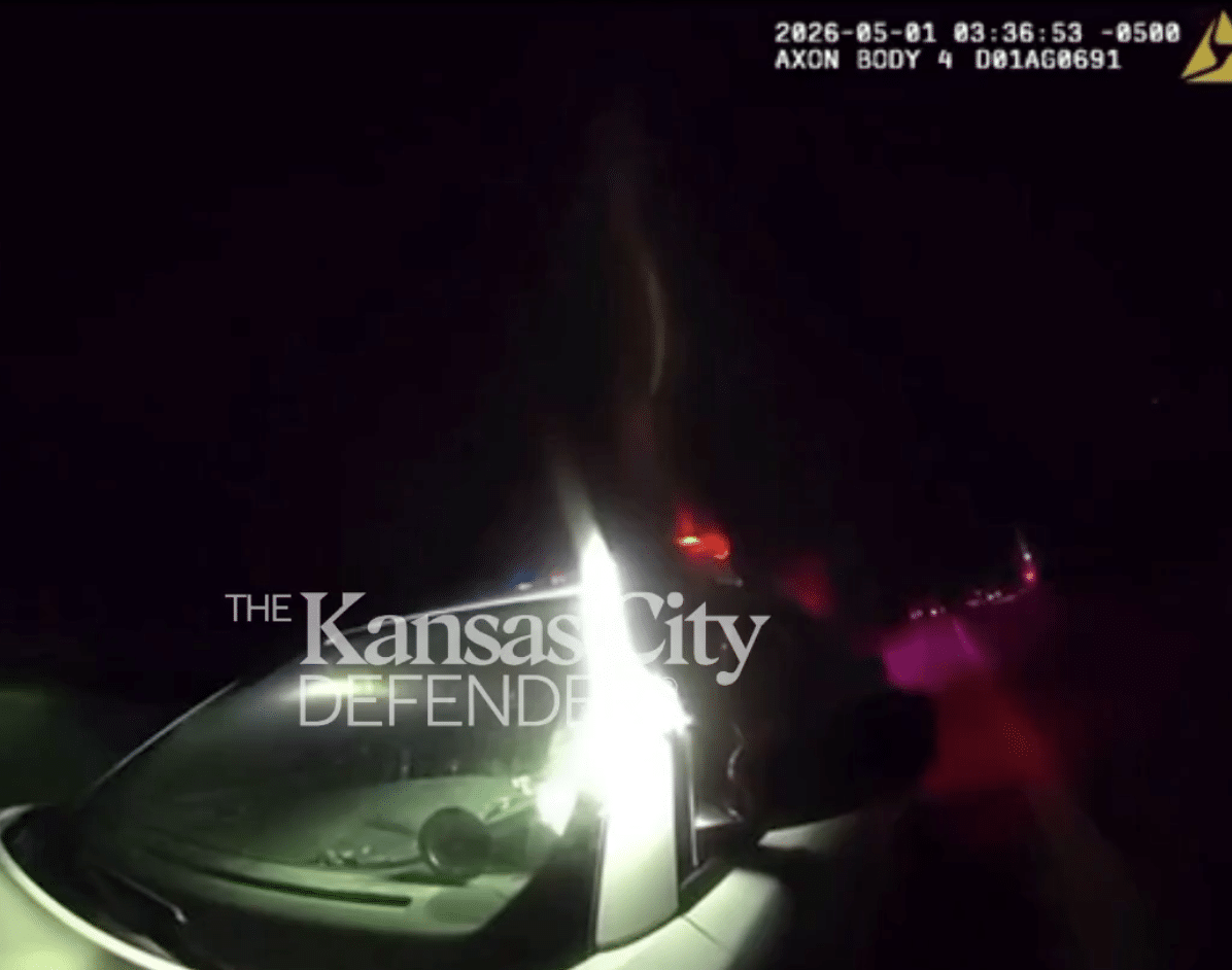 A frame from Odessa Police Officer Nathan Holmberg's body camera at 3:36 a.m. on May 1, 2026, showing a patrol car parked in the dark on U.S. Highway 50 before Saveion McConnell was shot.